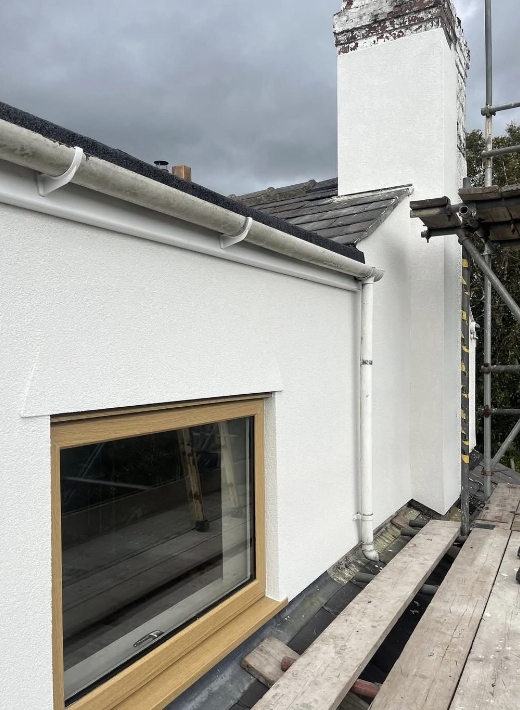 Chimney stack and dormer cheek rendered at high level from the scaffold