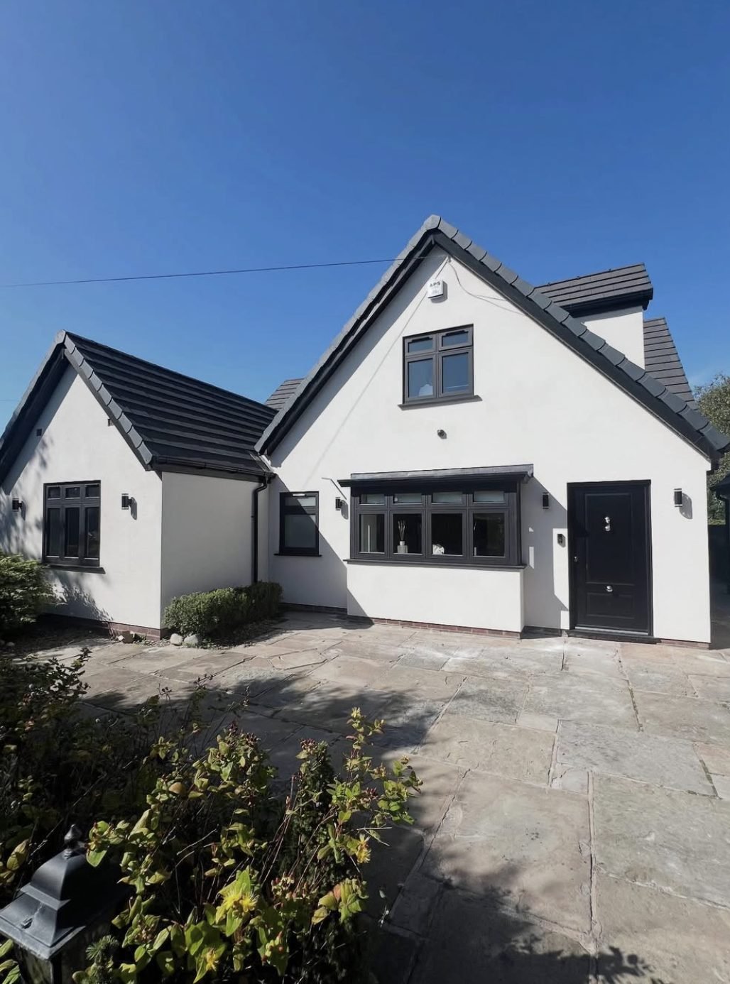 Dormer bungalow rendered white under a dark tiled roof